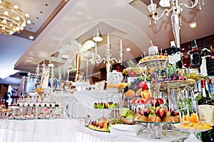 Different delicious fruits on wedding reception table.