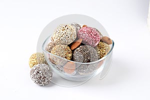 Different delicious vegan candy balls with almonds on white background