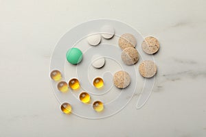 Different dietary supplements on white table, flat lay