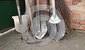 Different dirty rusty shovels, fan rake and hoe