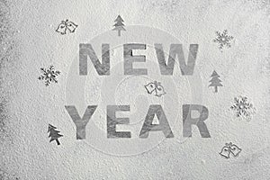 Different drawings and words New Year made of flour on grey table, top view