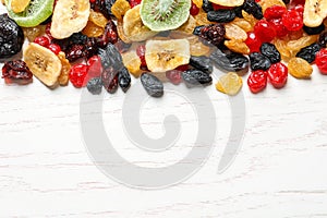 Different dried fruits on wooden background, top view with space for text