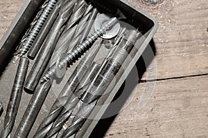 Different drills in a box. pile of drill bits in a case. work tools