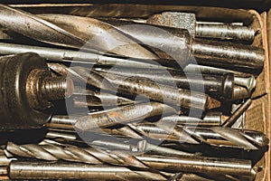 Different drills in a box. pile of drill bits in a case. work tools