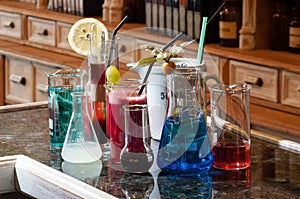 Different drinks and liquids in chemistry containers