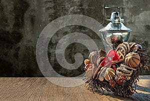 Different Dry fruits on a twigs pile shape of heart with ancient kerosene oil lamp