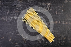 Different dry pasta on a wooden background. Top view