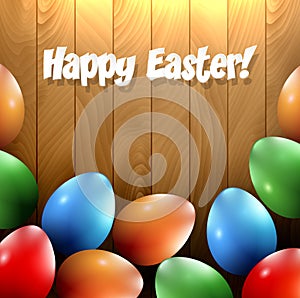 Different Easter eggs on a wooden background