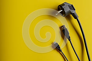 Different electric plug connector on yellow background with copy space