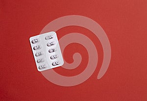 Different emotions when taking pills. copy space. red background
