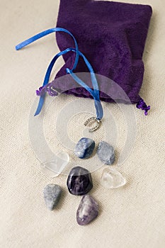 Different energy stones on a table next to your bag