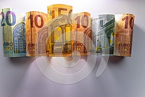 Different european bank notes illuminated as shiny bank note tubes with 50 euro, 20 euro, 10 euro and 5 euro