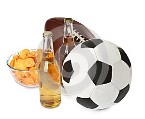 Different football balls, beer and chips on white background