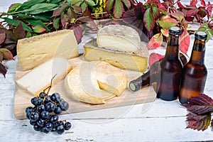 Different French cheeses with a few bottles of beer