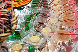 Different fresh alcoholic cocktail in glass on bar table, many colorful drinks.