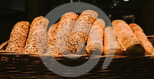 Different fresh bread on the shelves in bakery. Selective focus