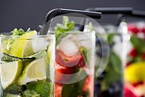 Different fresh lemonades in glasses with ice cubes