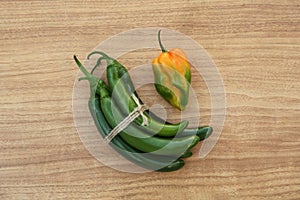 Different fresh ripe peppers on wooden table, flat lay