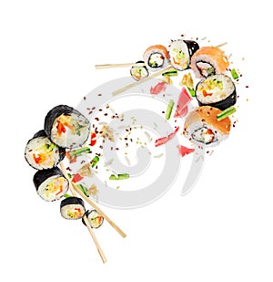 Different fresh sushi rolls with chopsticks hovered in white space