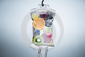 Different Fruit Slices Inside Saline Bag Hanging In Hospital photo