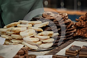 Different fruits such as ananas covered in brown, black and white chocolate. Delicious treat on a display