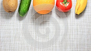 Different fruits and vegetables on a light background. Frame, space for text, copy space