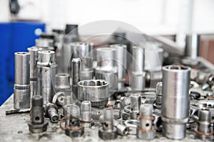 Different fuel bolts and end keys on a workbench in a fuel workshop.