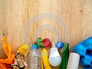 Different garbage on wooden background, top view. Reuse, reduce, recycle concept