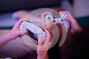 Different generations of PlayStation console controllers: PS5 DualSense controller and PS4 DualShock controller in a