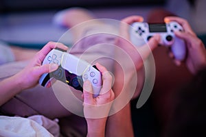 Different generations of PlayStation console controllers: PS5 DualSense controller and PS4 DualShock controller in a