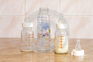 Different glass bottle with the mixture for feeding the baby