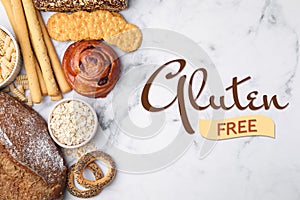 Different gluten free products on white marble table, flat lay
