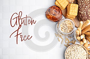 Different gluten free products on white tiled table, flat lay