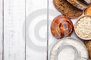 Different gluten free products on white wooden table, flat lay. Space for text
