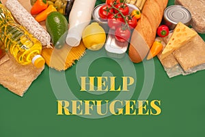 Different groceries, food donations on green background with copy space - pasta, fresh vegatables, canned food, baguette, cooking