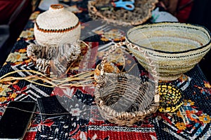 Different hand made weave basckets on table. Craft workshop. Close up shot