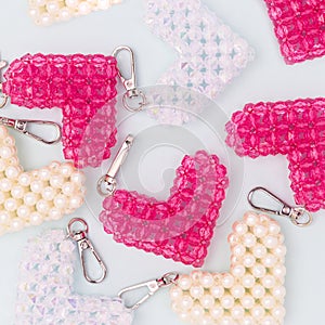 Different handcraft keychains in a heart shape made from acrylic beads.