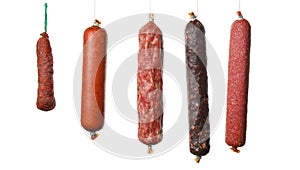 Different hanging sausages isolated on background