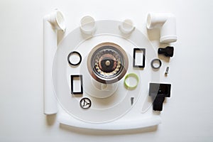 Different hardware elements and tubes for a kitchen sink drain