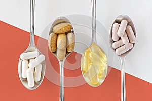 Different healthy supplements on teaspoons