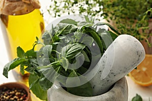 Different herbs, oil and spices on wooden background, closeup