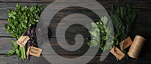 Different herbs on wooden background, top view