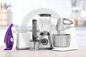 Different household and kitchen appliances on table indoors. Interior element