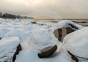 different ice formations on rocks on the seashore, ice texture, wind, water and ice working together