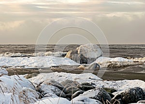different ice formations on rocks on the seashore, ice texture, wind, water and ice working together