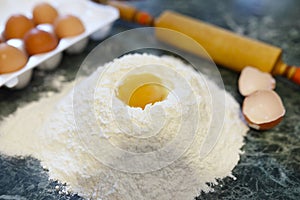 Different ingredients for preparing flour products on kitchen ta
