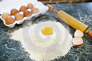 Different ingredients for preparing flour products on kitchen ta
