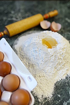 Different ingredients for preparing flour products on kitchen ta