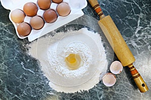 Different ingredients for preparing flour products on kitchen ta