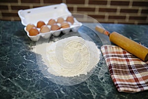 Different ingredients for preparing flour products on kitchen ta